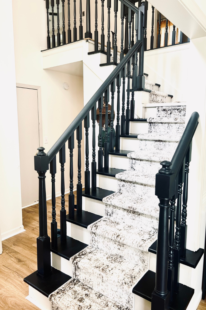 black painted stairs with runner