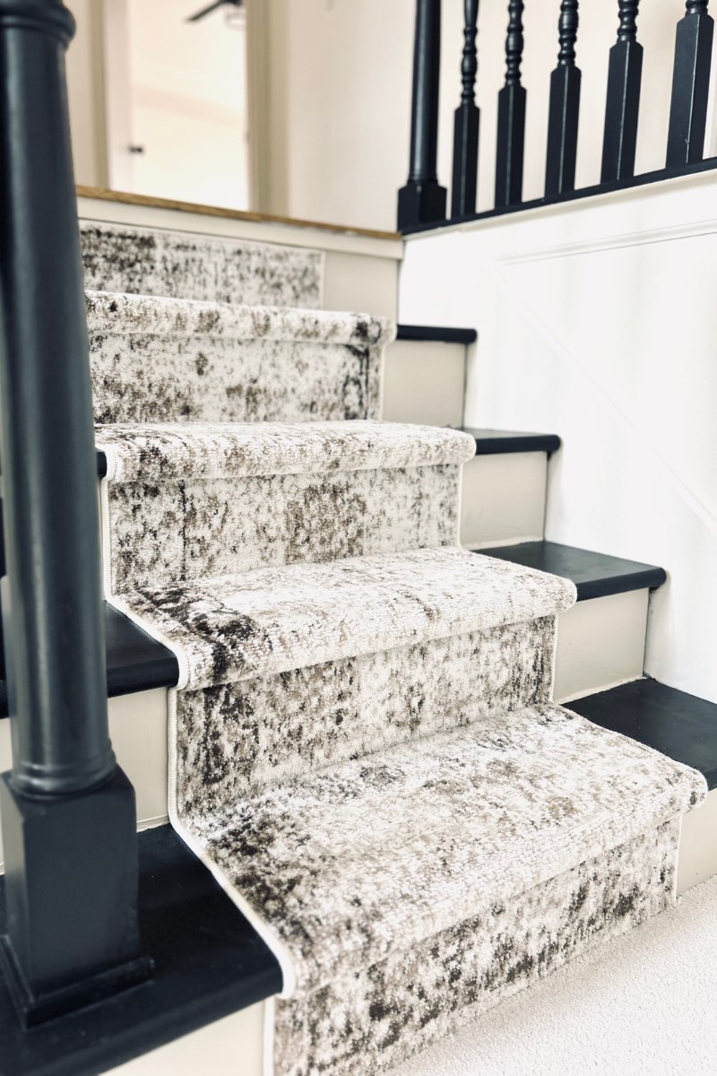 black painted stairs with runner