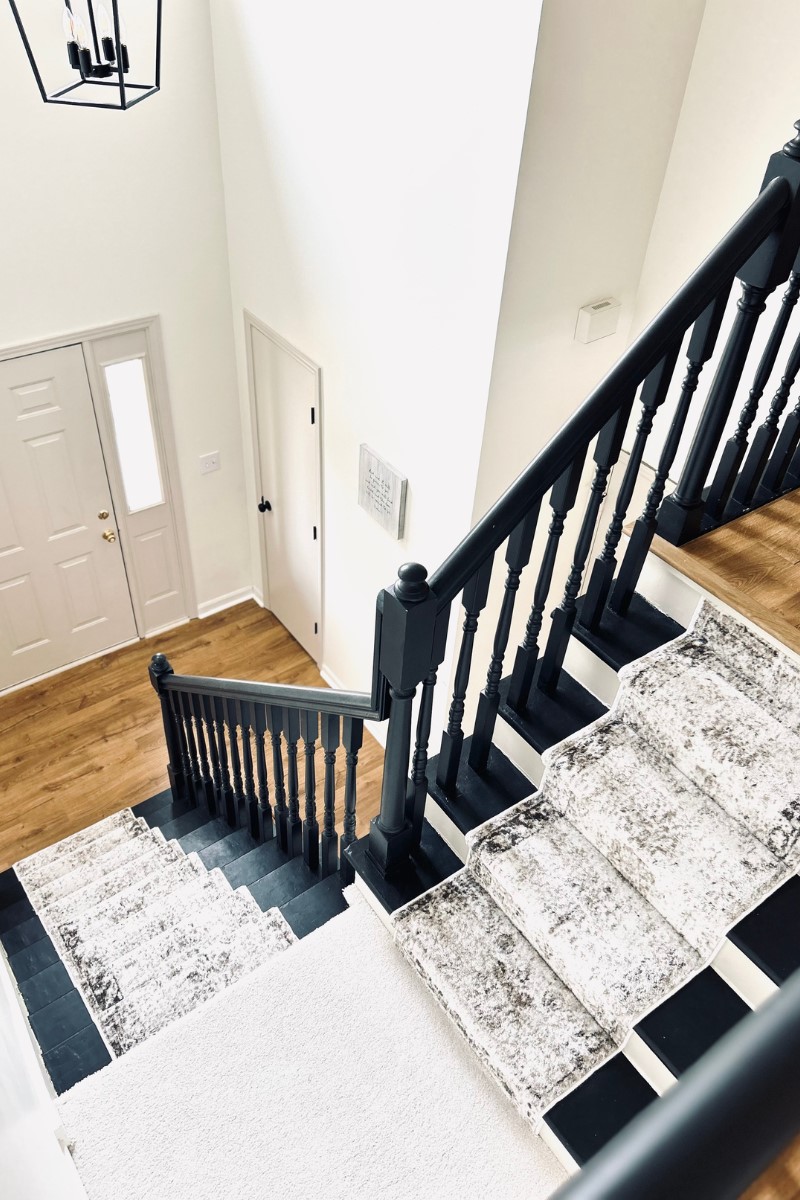 black painted stairs with runner
