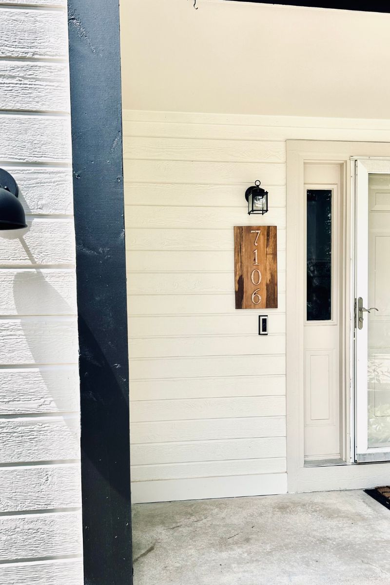 front porch with wooden numbers sign