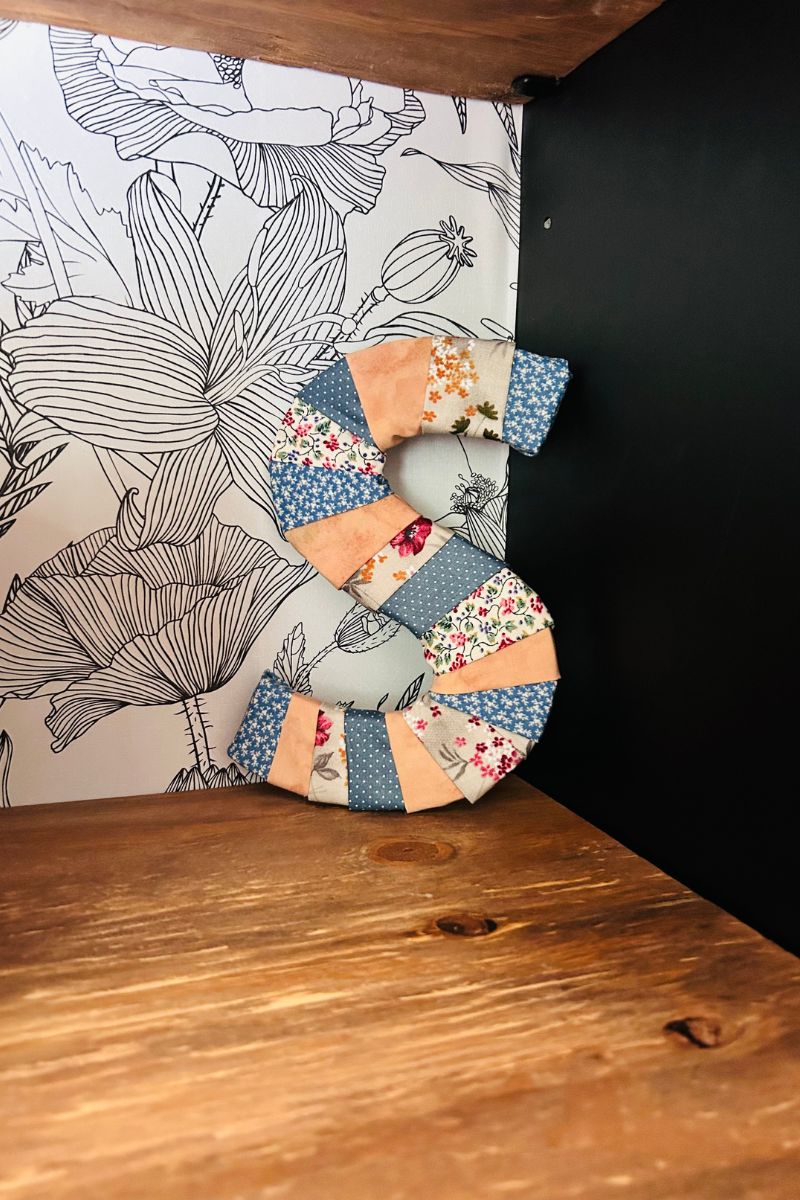 DIY fabric letter decor on nursery shelf