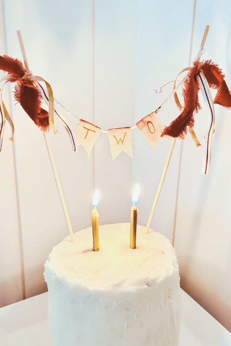 DIY cake topper on white tiered cake