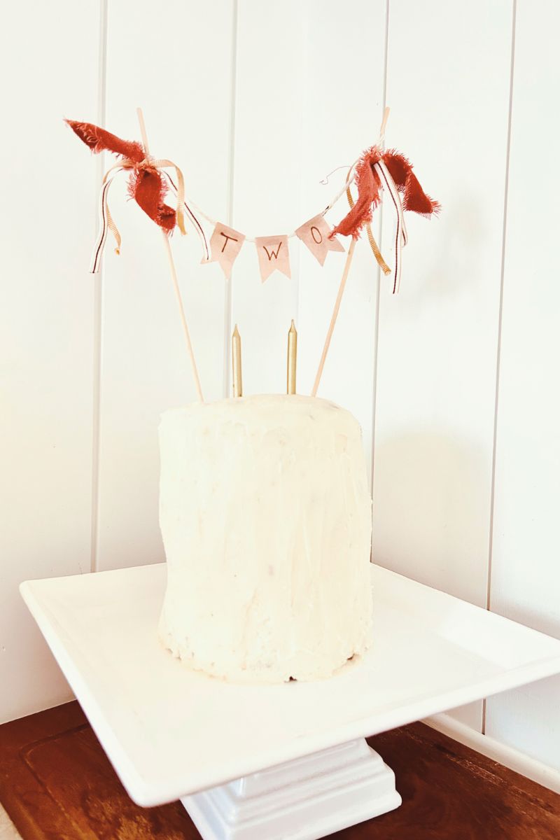 DIY cake topper on  white tiered cake