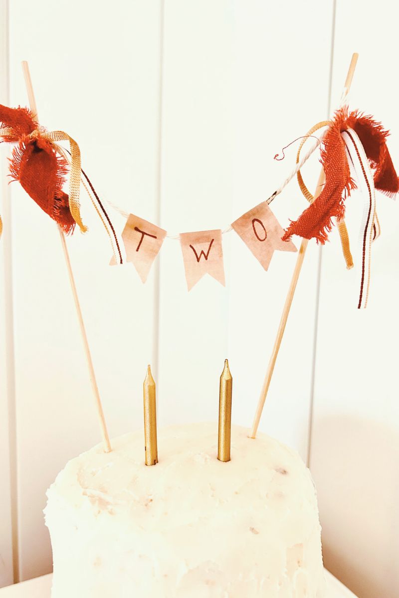 DIY cake topper on white tiered cake
