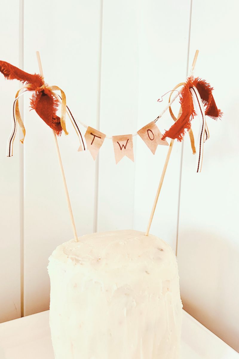 DIY cake topper on white tiered cake