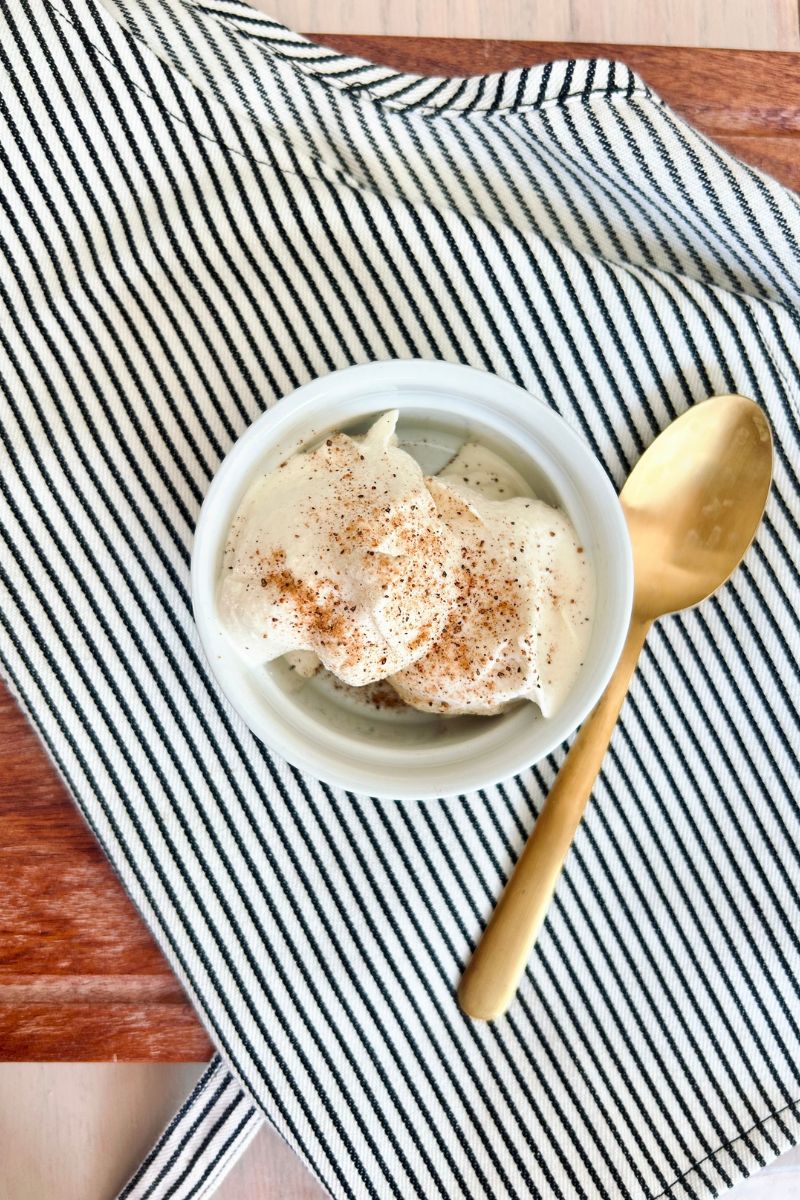 egg nog protein ice cream in dish with gold spoon